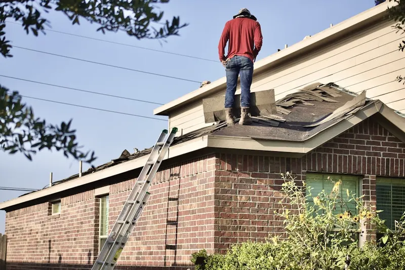 Professional roofer working on a residential roof in Lavaca